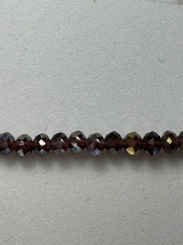 Row of dark brown faceted beads.