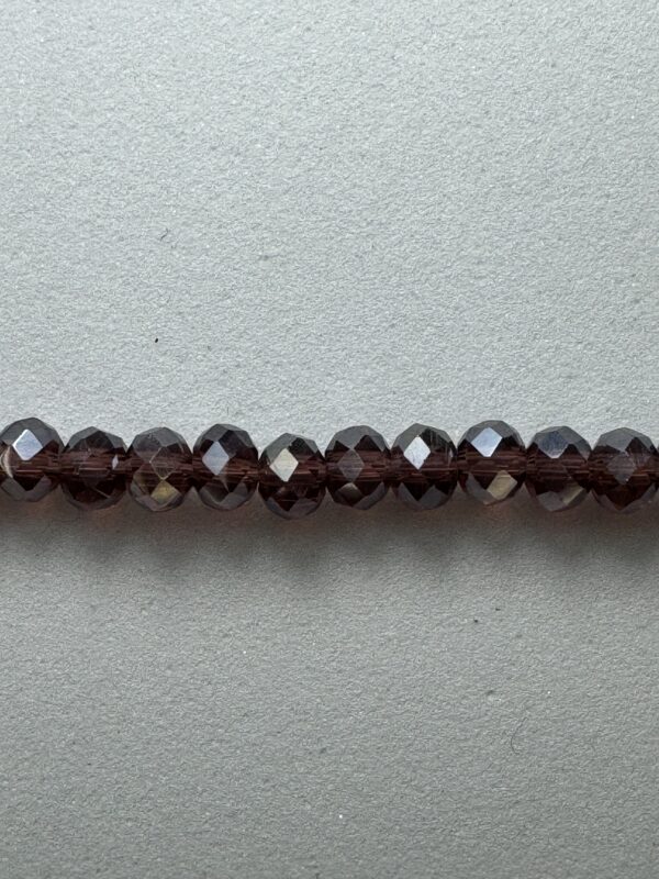 Row of dark brown glass beads.