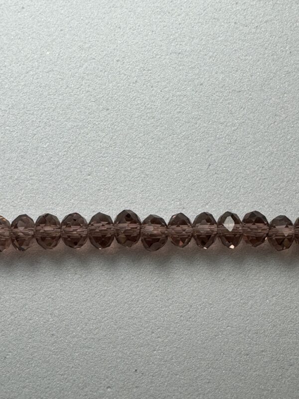 Row of dark brown faceted beads.