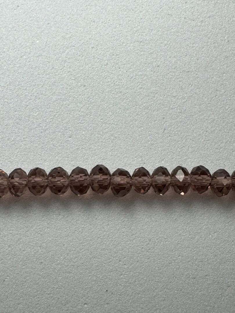 Row of dark brown faceted beads.