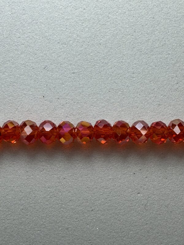 Row of red iridescent glass beads.