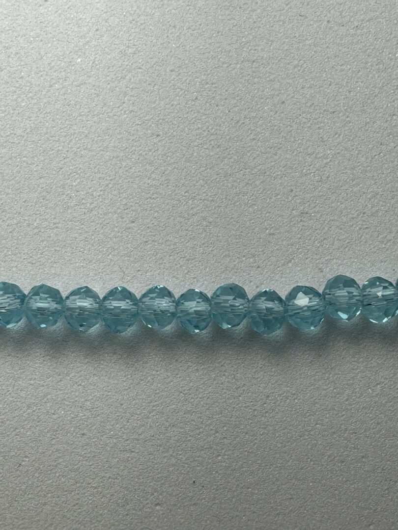 A row of light blue glass beads.