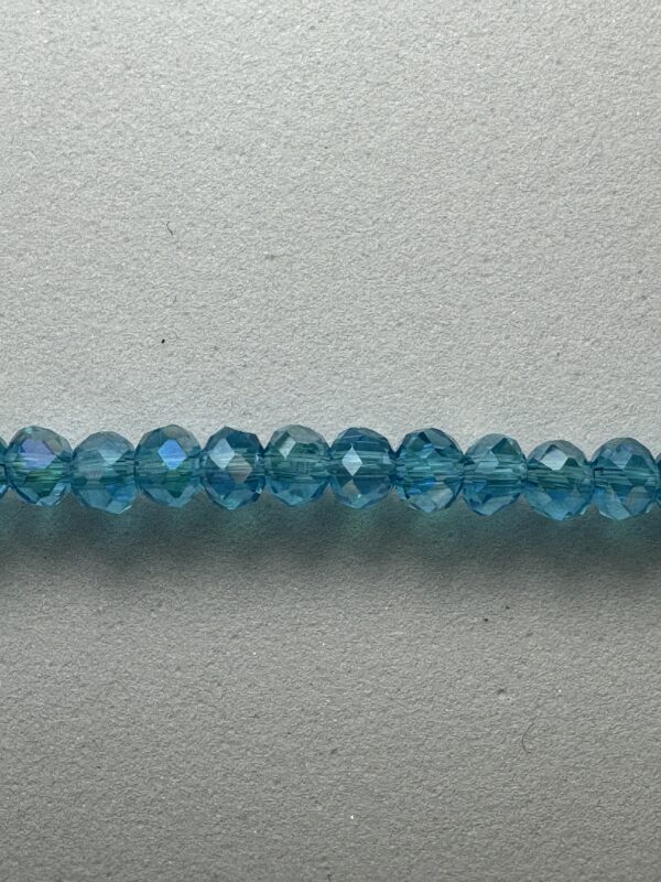 Row of blue faceted glass beads.