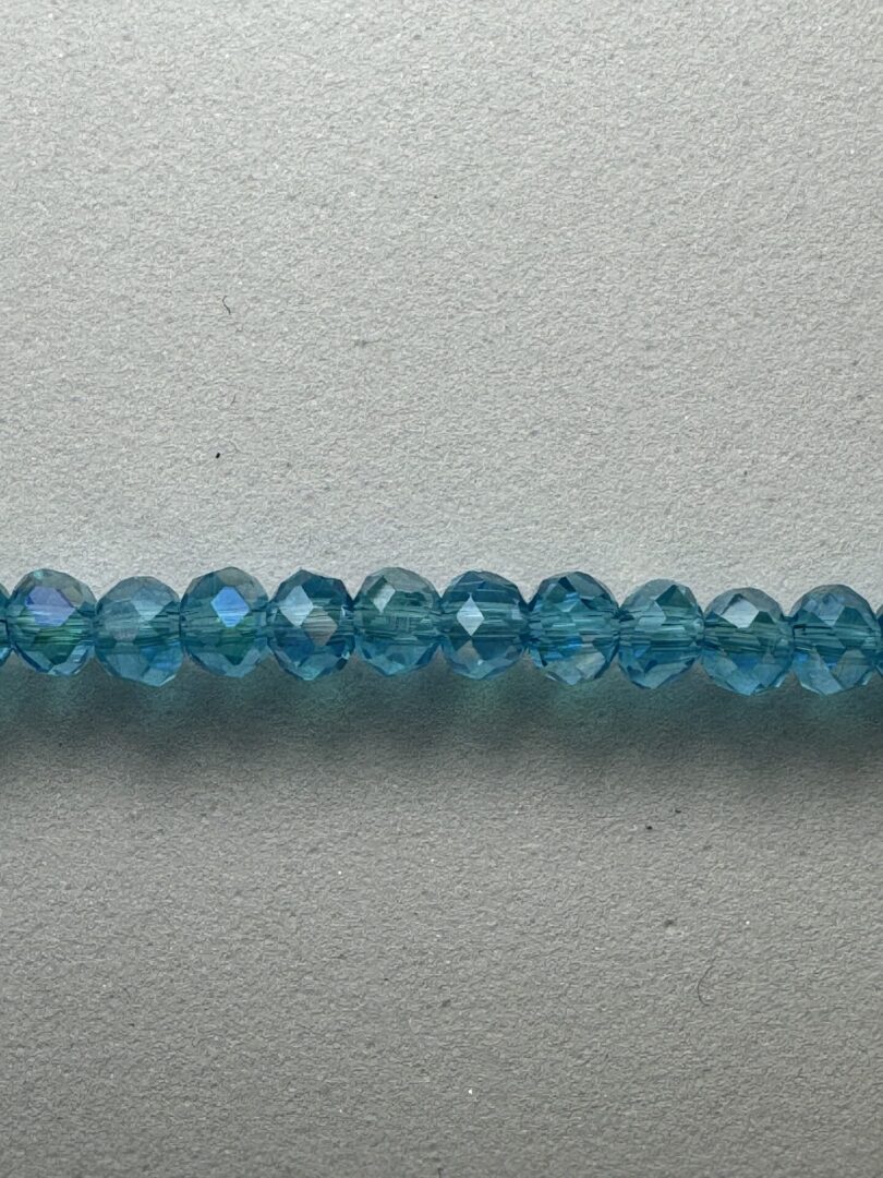 Row of blue faceted glass beads.