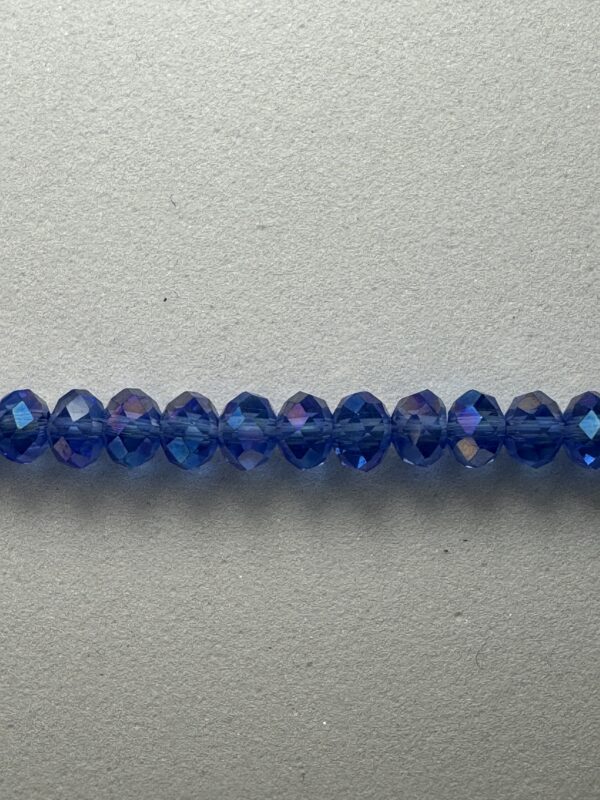 Row of iridescent blue glass beads.