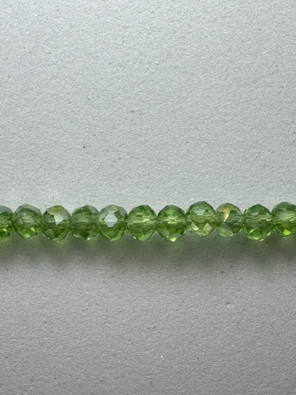 Row of green faceted glass beads.