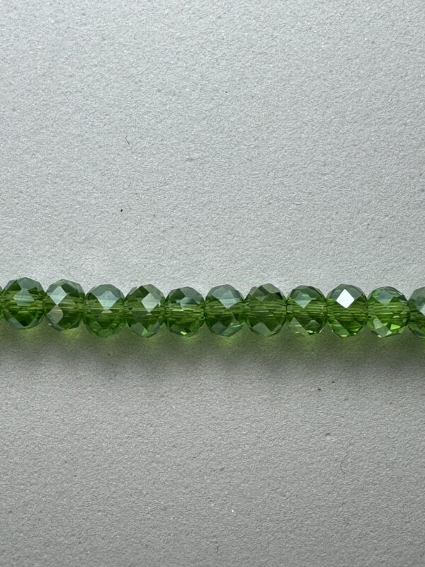 Row of green faceted glass beads.