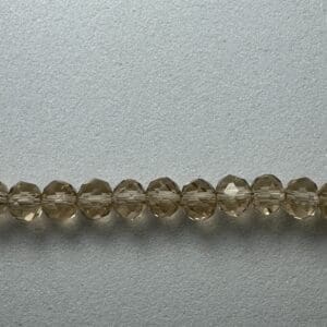 Row of brown faceted glass beads.