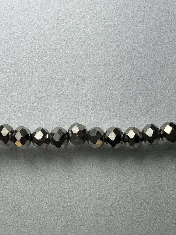 Row of shiny black faceted beads.