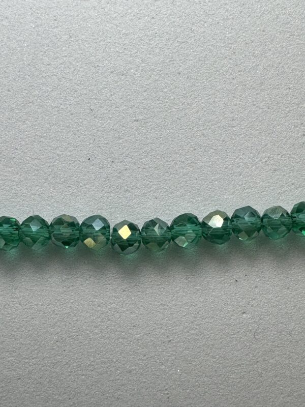 Row of green faceted glass beads.