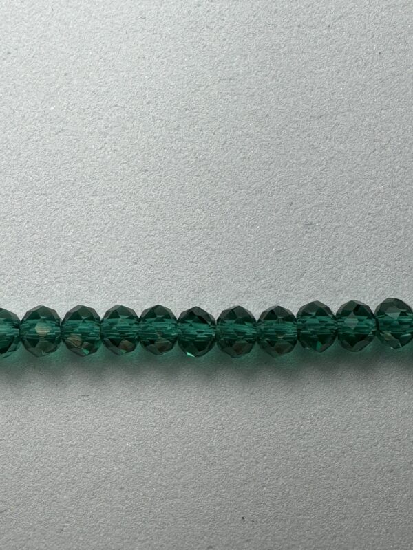 Row of dark green faceted beads.