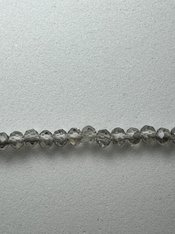 Row of gray faceted glass beads.