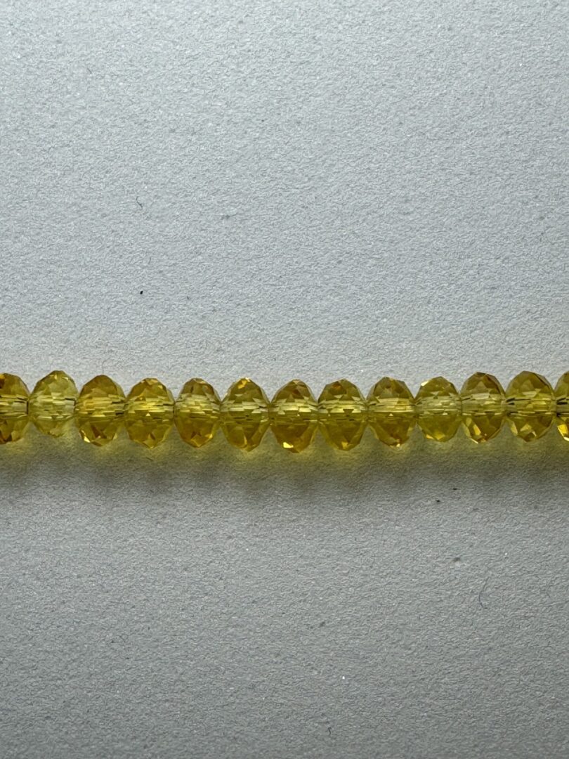 A row of yellow faceted beads.