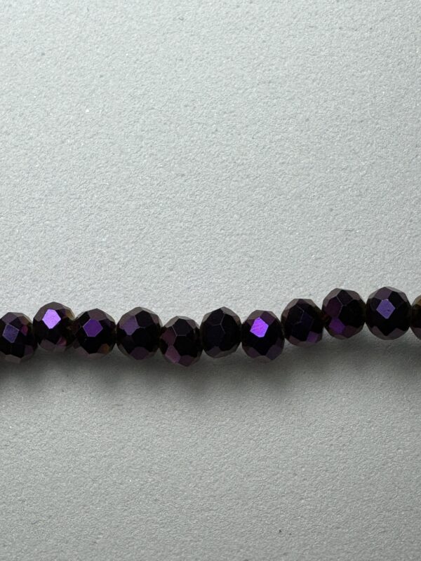 Row of dark purple iridescent beads.