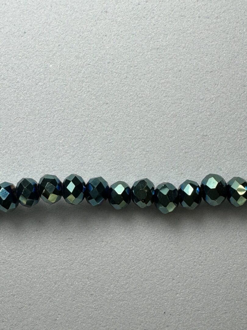 Row of dark blue iridescent beads.