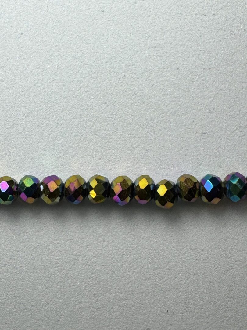 Row of iridescent faceted beads.