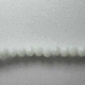 White faceted beads on a gray background.