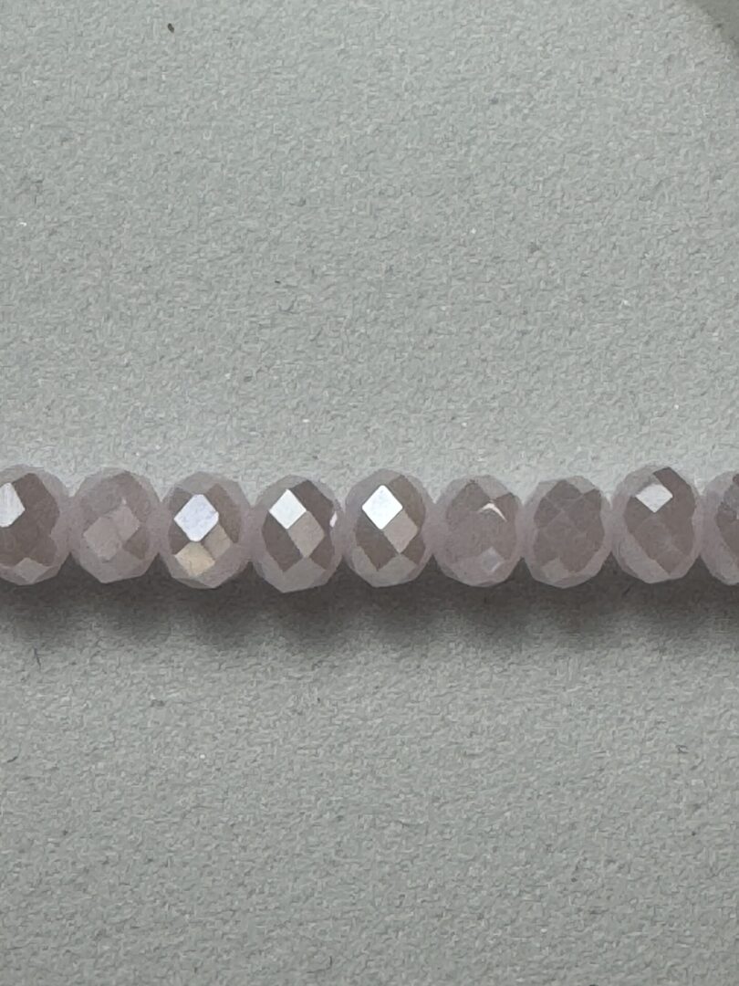 Row of pale pink faceted beads.