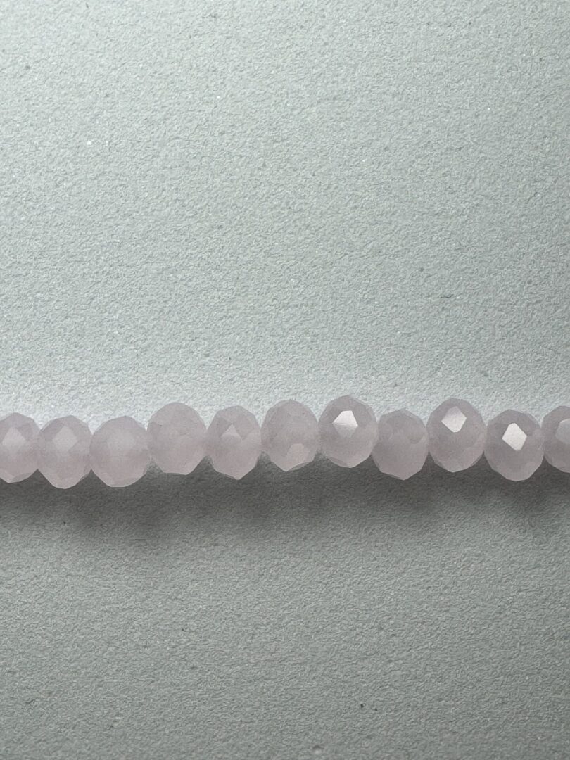 Row of light pink faceted beads.