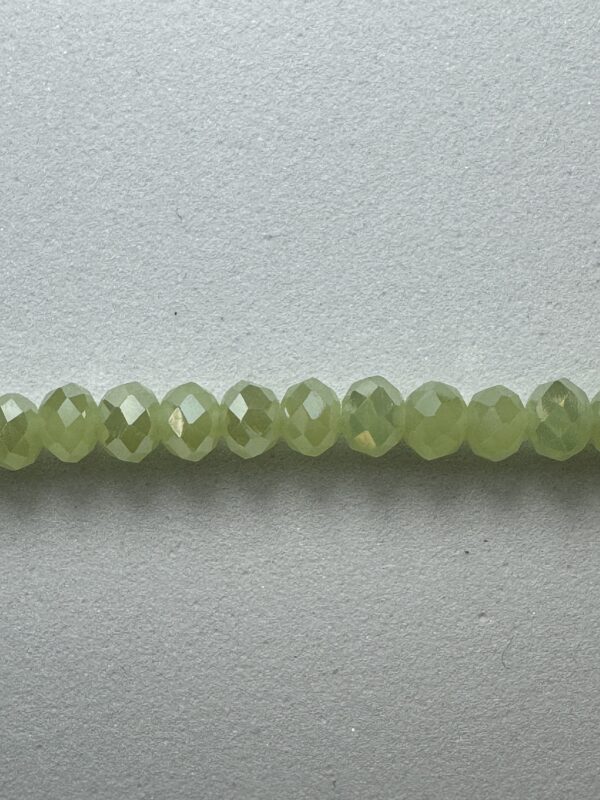 Row of light green faceted beads.