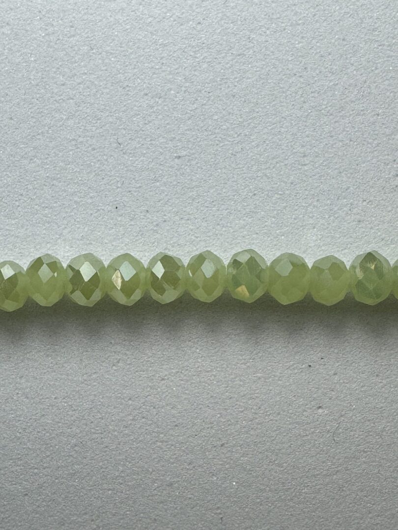 Row of light green faceted beads.