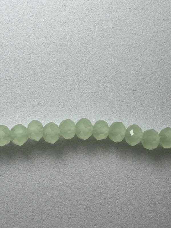 String of light green faceted beads.