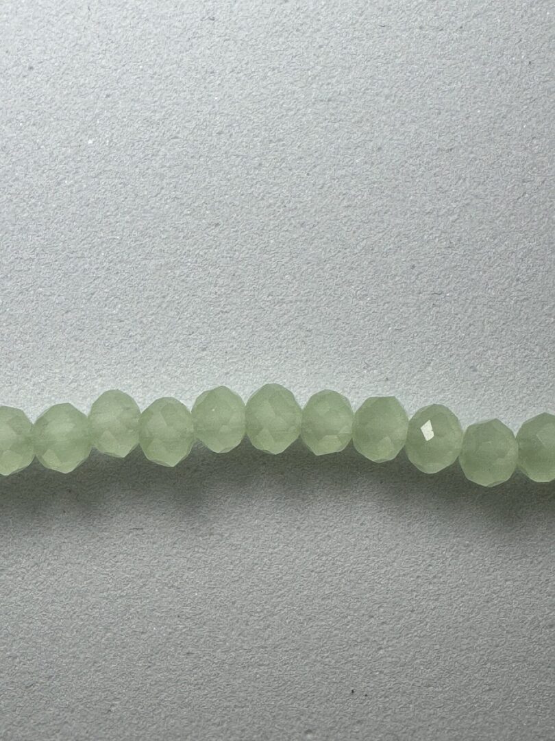 String of light green faceted beads.