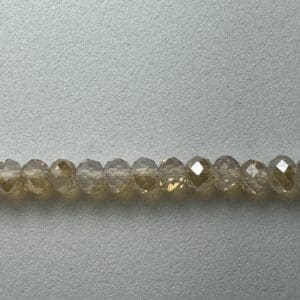 Row of clear faceted glass beads.