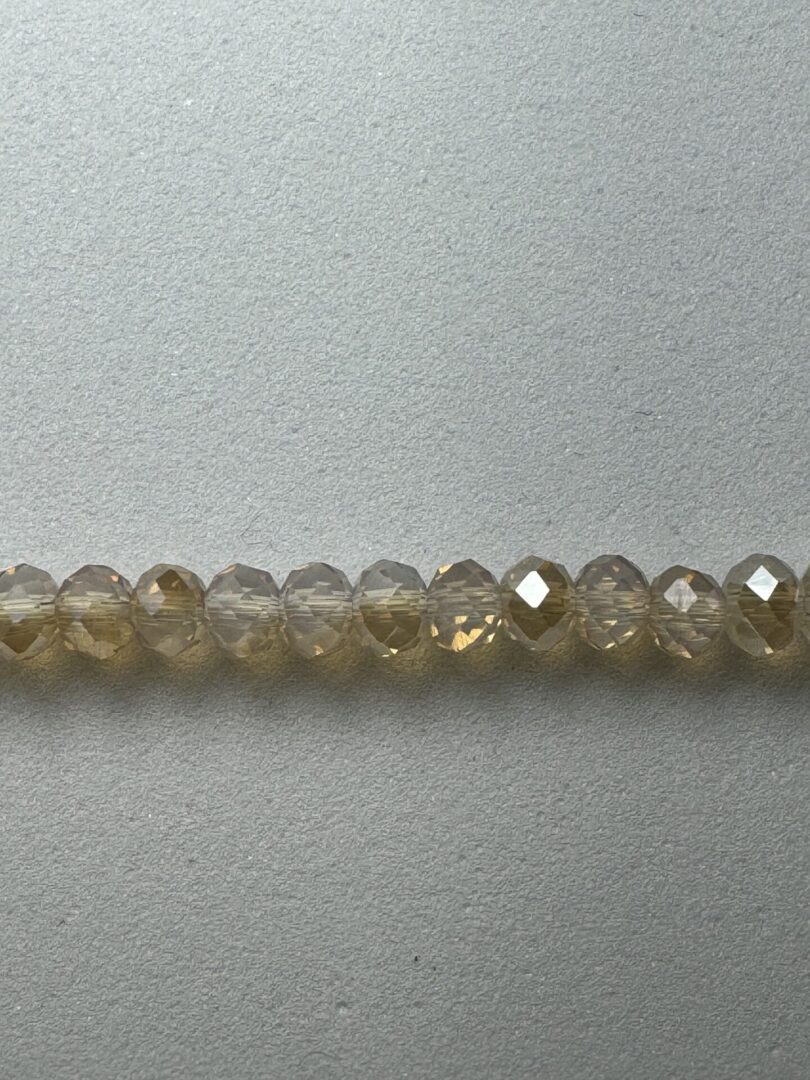 Row of clear faceted glass beads.