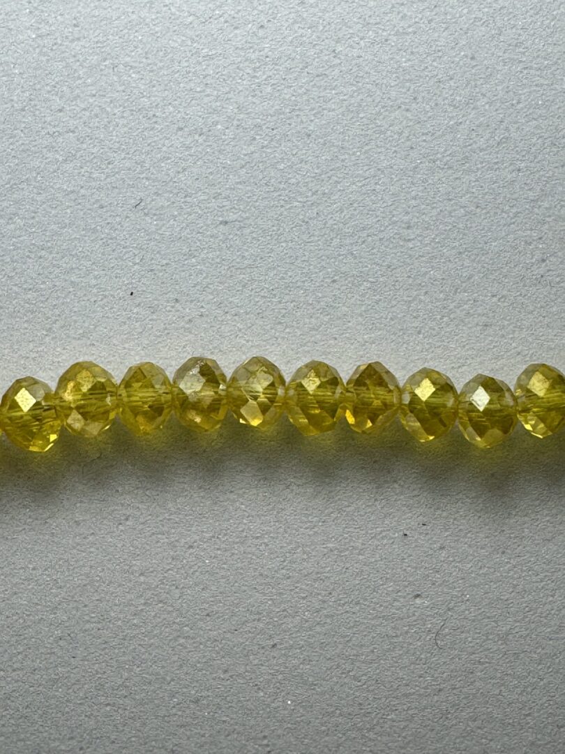 Row of yellow faceted beads.