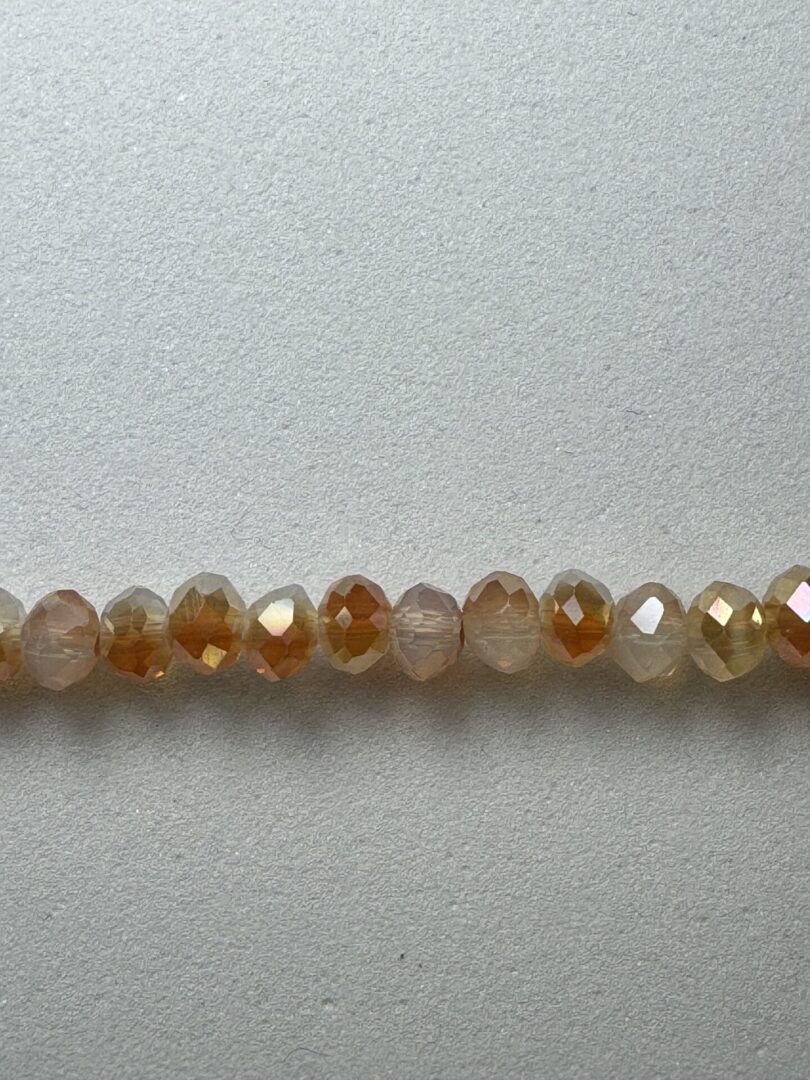 Row of iridescent brown glass beads.