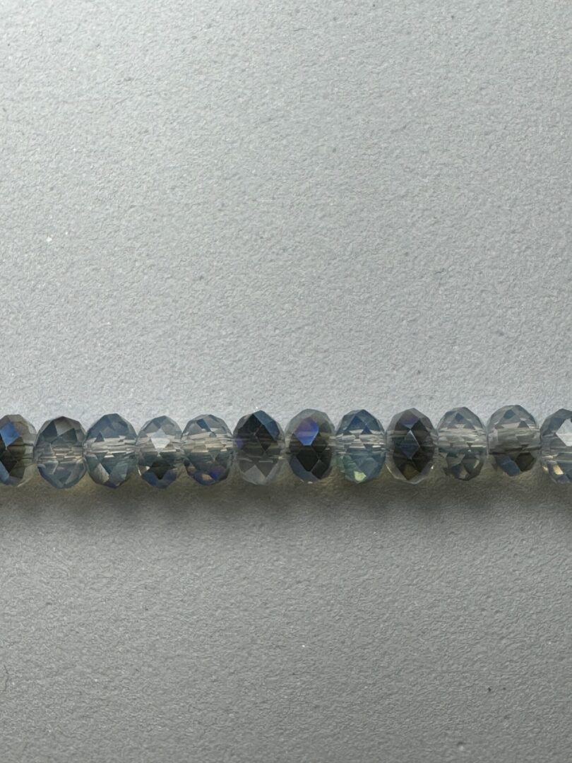 Row of iridescent faceted glass beads.