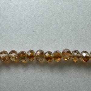Row of amber faceted glass beads.