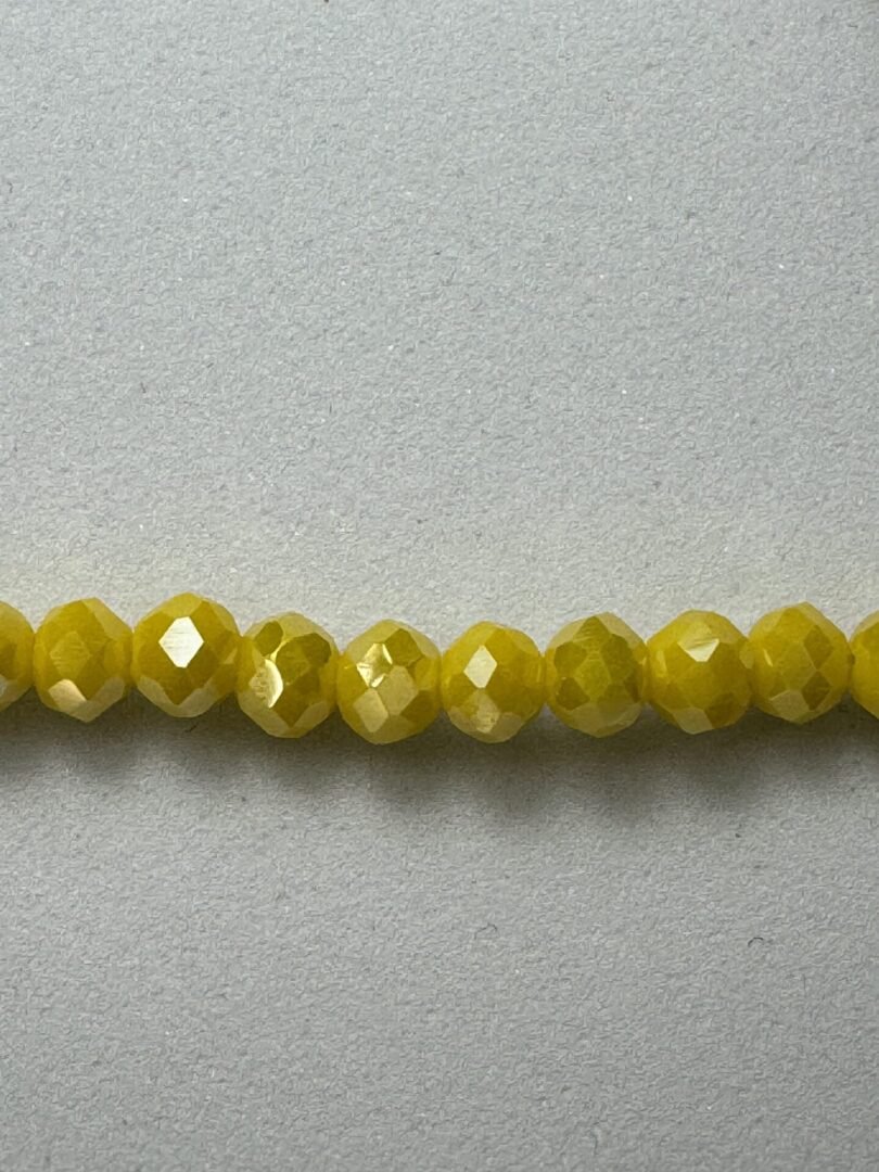 Row of bright yellow faceted beads.