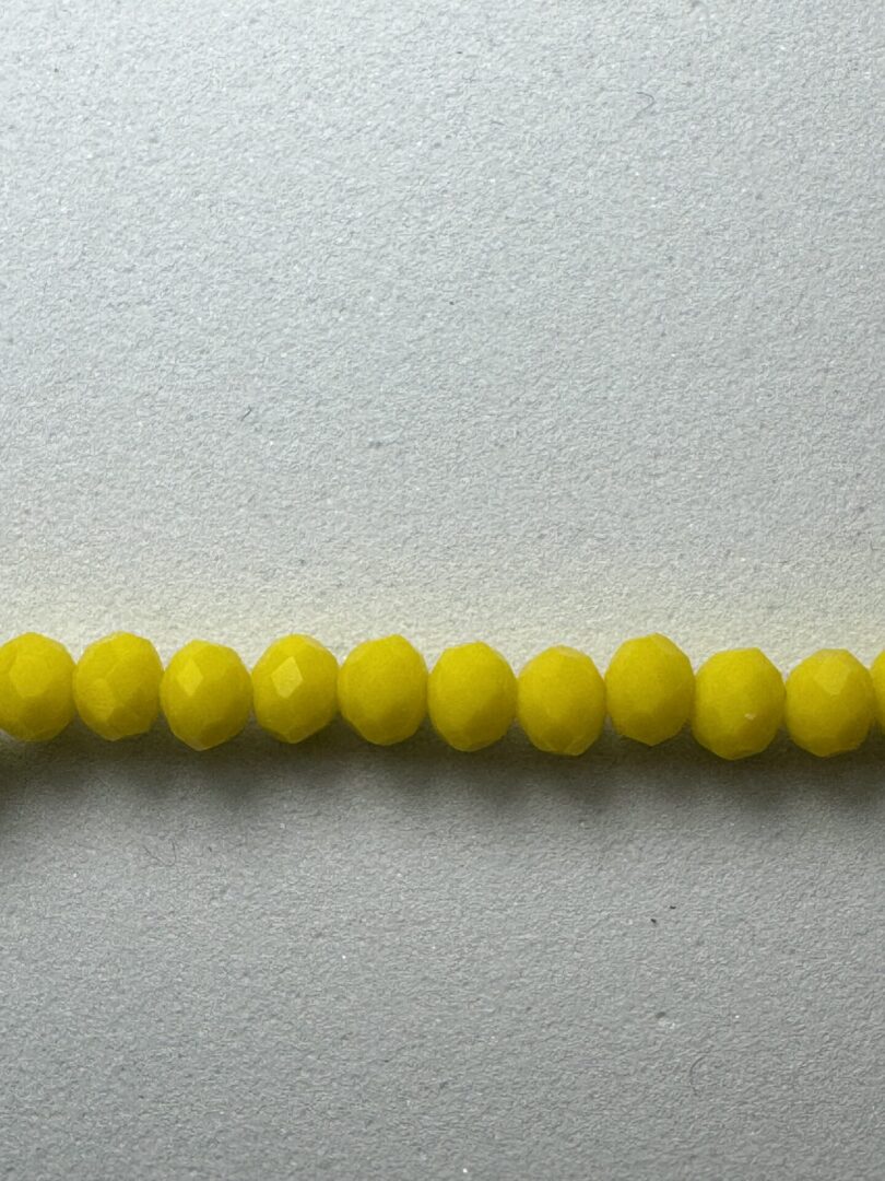 Row of bright yellow glass beads.