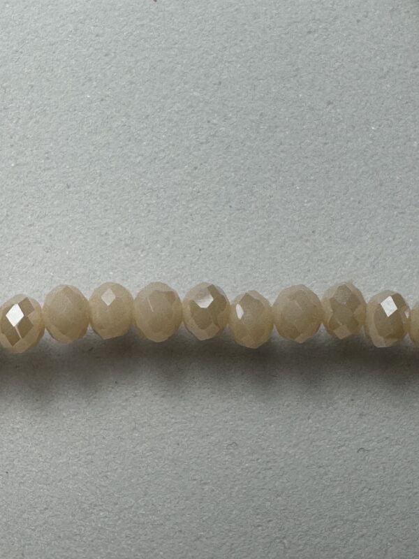 Row of pale, faceted glass beads.