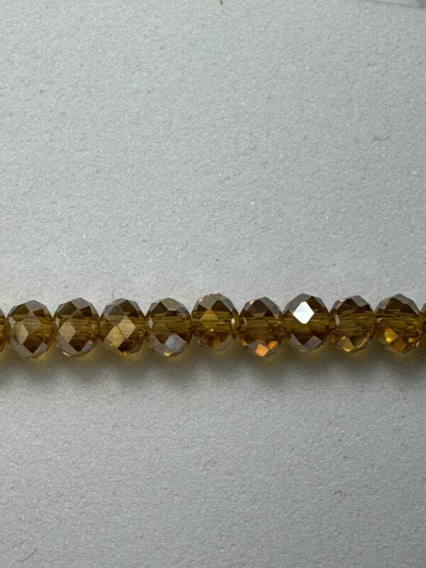 Row of faceted amber glass beads.