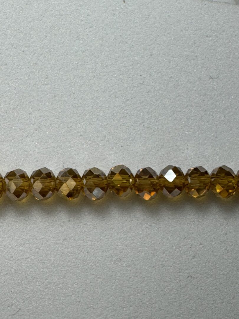 Row of faceted amber glass beads.