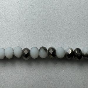Row of white and black faceted beads.