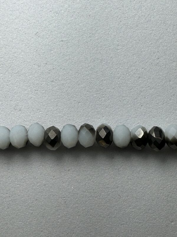 Row of white and black faceted beads.