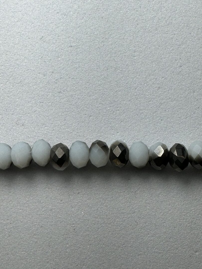 Row of white and black faceted beads.