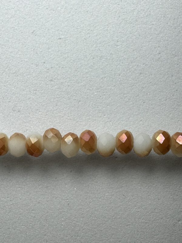 Row of iridescent brown and white beads.