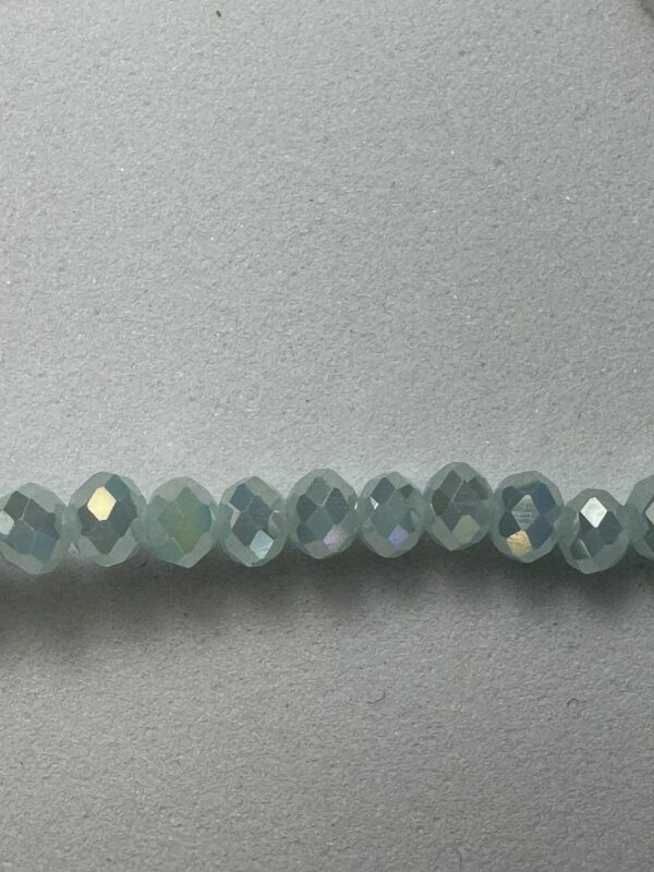 Row of light blue iridescent beads.