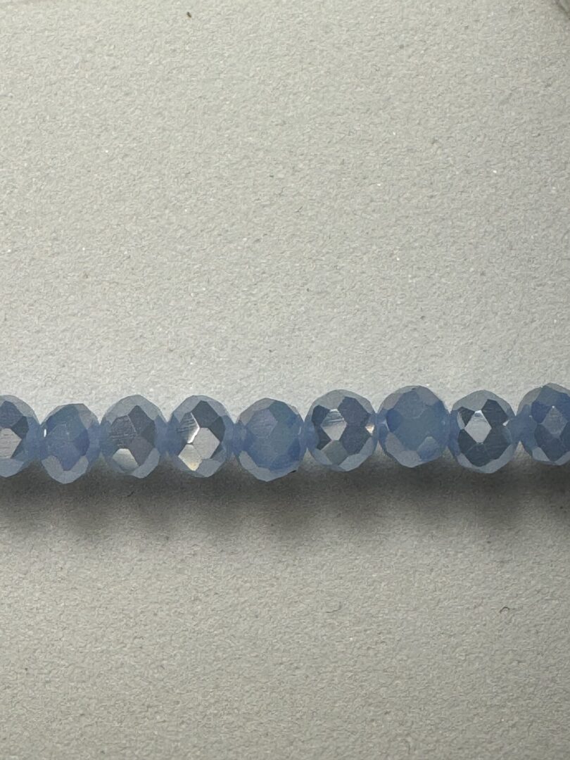 Row of light blue faceted beads.