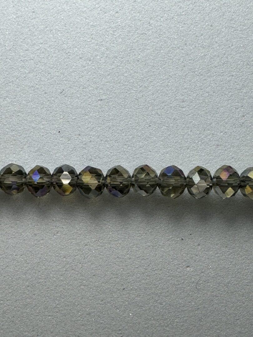 Row of iridescent brown glass beads.