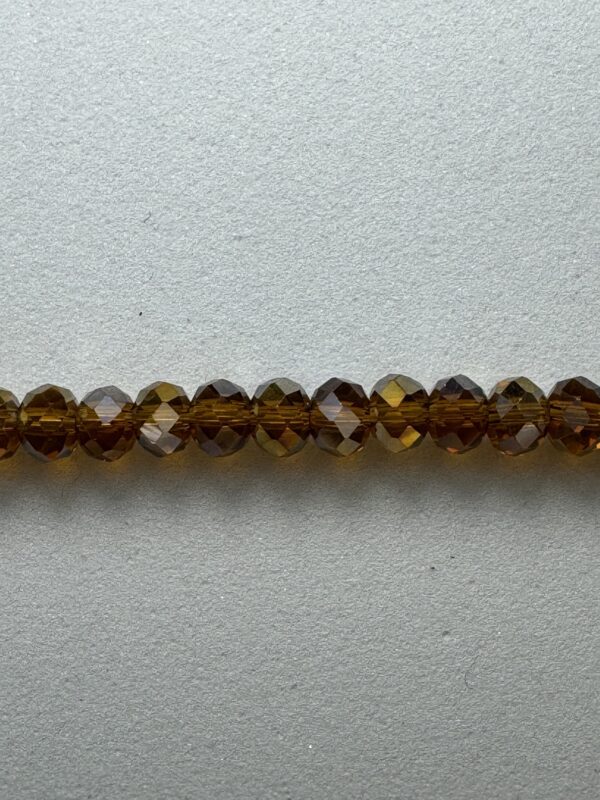 Brown faceted glass beads on white background.