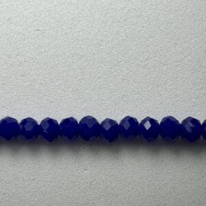 Row of dark blue faceted beads.