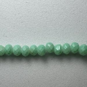 Row of light green faceted beads.