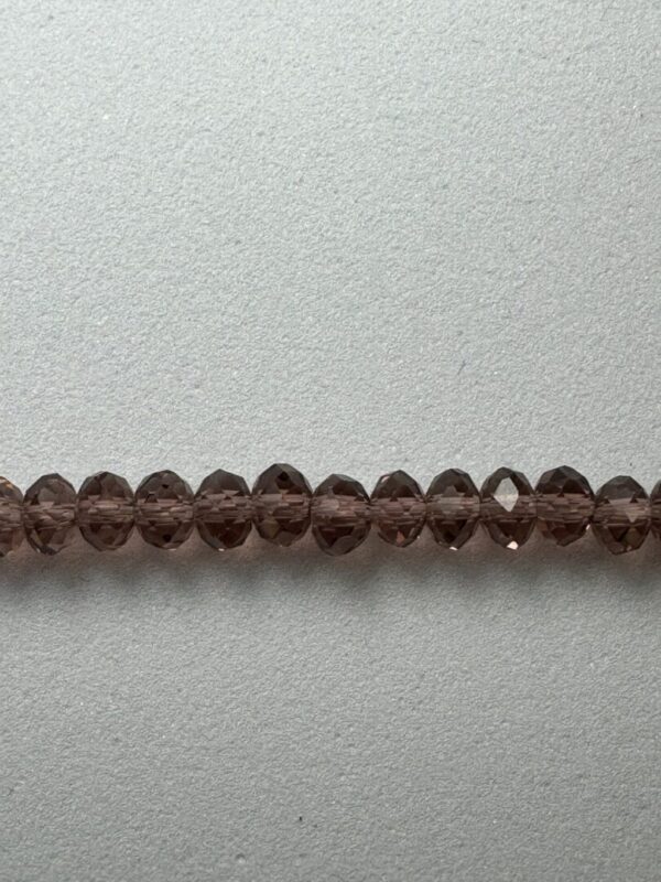 Row of brown faceted glass beads.