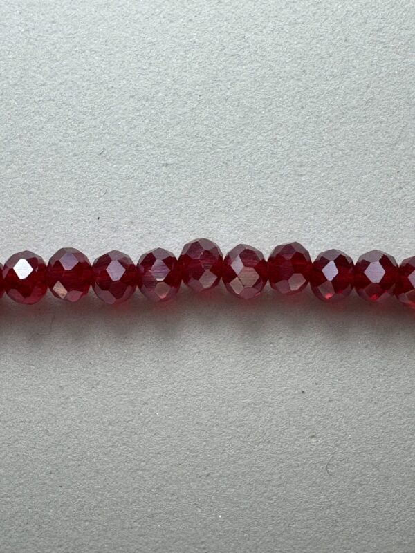 Row of red faceted glass beads.